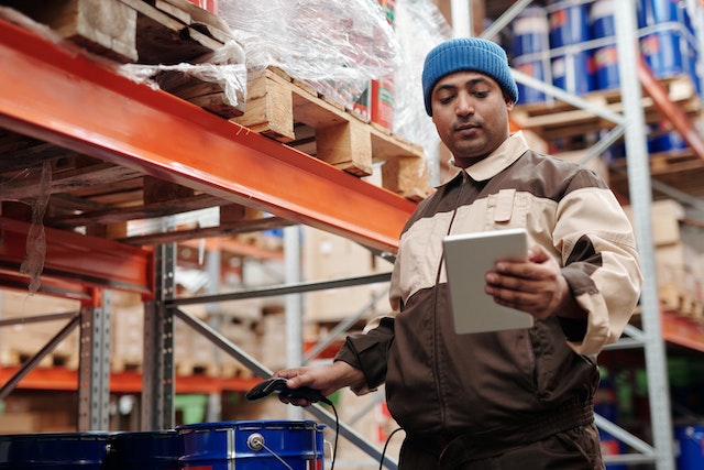 warehouse worker using tablet for inventory tracking